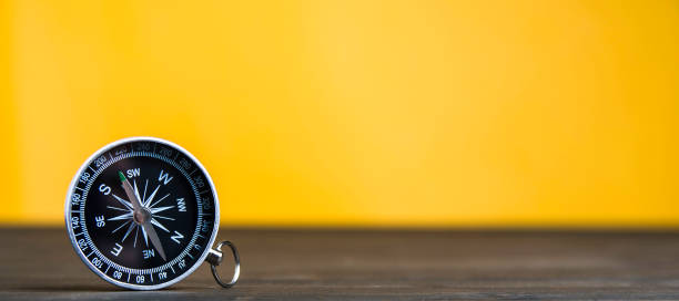 old compass on an yellow background. copy space for text or design - 5461 imagens e fotografias de stock