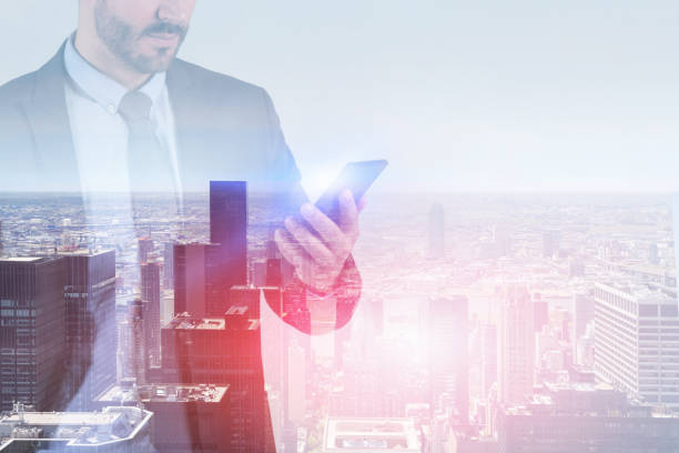 istock Businessman with smartphone in city 1137983657