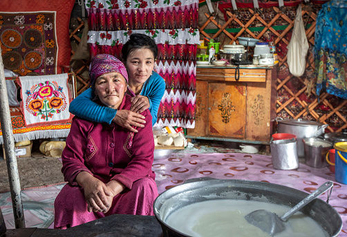 Bayan Ulgii, Mongolia, 29th September 2015: kazakh nomad mother and daughter in their home yurt kitchen area
