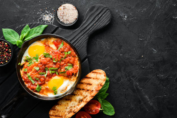 istock Shakshuka Scrambled eggs with tomatoes and vegetables. Breakfast. In the plate. Top view. Flat lay composition Free copy space. 1137987299