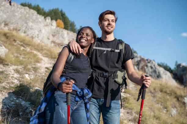 istock Young couple hiking on mountain trail 1137987389