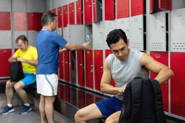 istock Men getting ready to workout at the gym in the locker room 1137988513