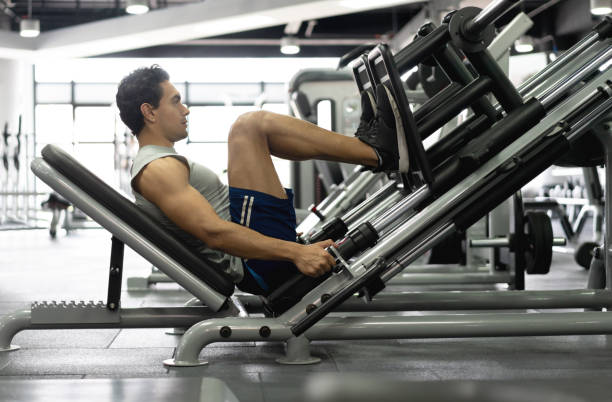 Afro Latina woman of average age of 25 years dressed in sportswear is inside the gym where she trains her body hard