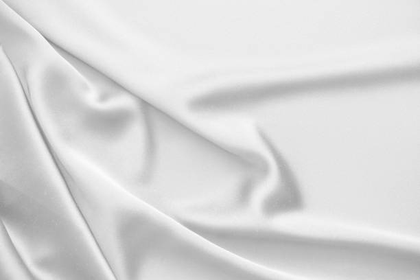 istock Rippled white silk fabric satin cloth waves background 1137988670