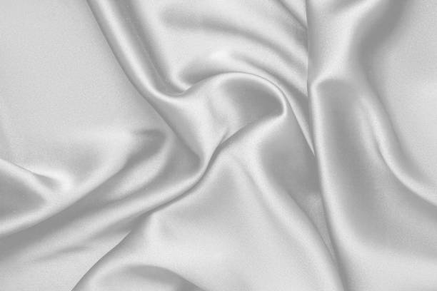 istock Rippled white silk fabric satin cloth waves background 1137989713