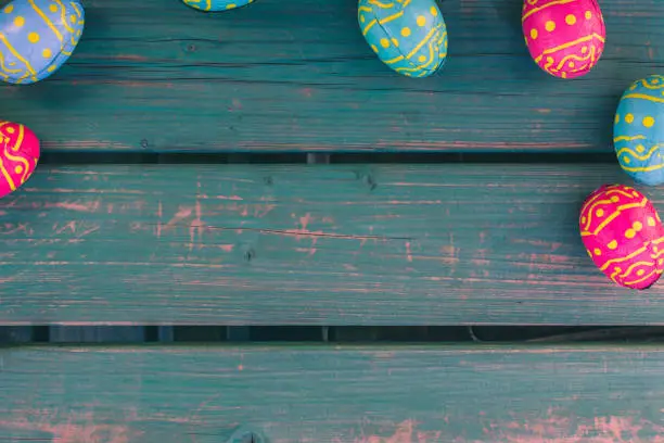 Colored easter eggs in a bowl standing on a green wooden bench, Amsterdam the Netherlands, 23 march 2019