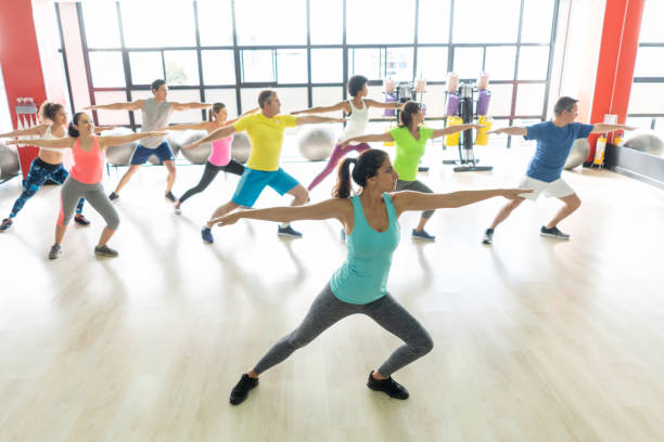 istock People at a yoga class in the gym following instructor 1137990918