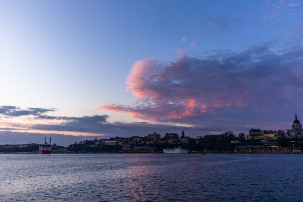 a red, colorful sunrise on the sea in the harbor of  stockholm in winter  with the backdrop of the old town - 2 - stockholm harbor sweden winter imagens e fotografias de stock