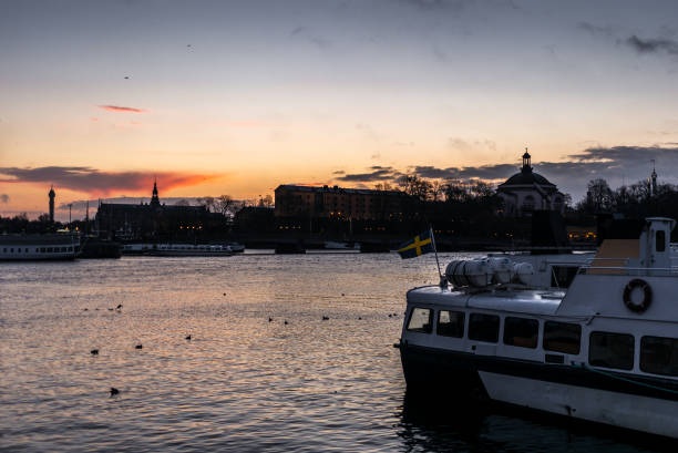 ships, towers and bridges in the harbor of  stockholm during a colorful sunrise in winter   - 1 - stockholm harbor sweden winter imagens e fotografias de stock