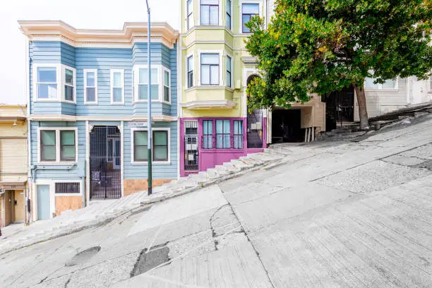 Classic urban scene of historic colorful buildings along one of San Francisco's steepest streets near Telegraph Hill residential area district on a beautiful sunny day in summer, SF, California, USA