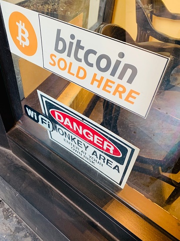 Los Angeles, USA - January 02, 2019: Bitcoin sold here Sign on shop door in Los Angeles Downtown, USA