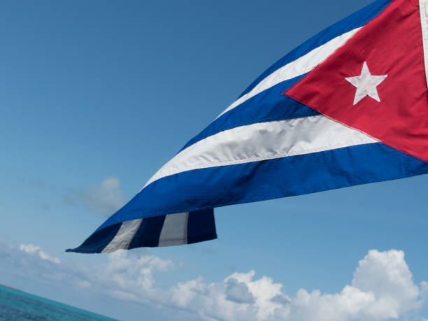 istock Cuba national flag closeup blue sky background 1137999438