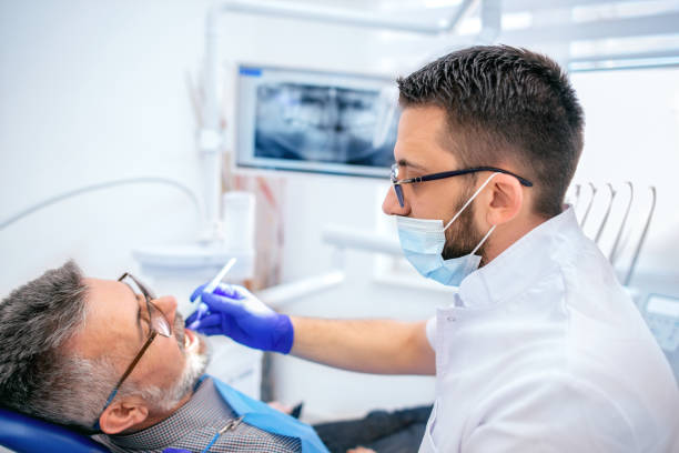 istock Mature man at the dentist 1138000920