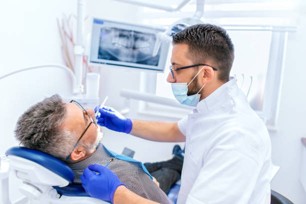istock Mature man at the dentist 1138002416