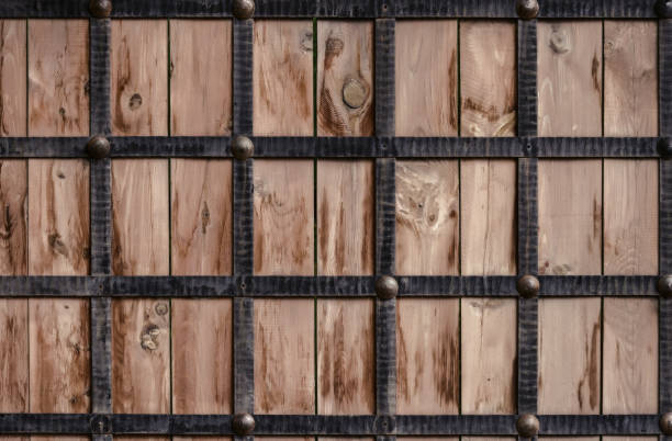 istock Wooden texture framed by metal forged strips. 1138003452