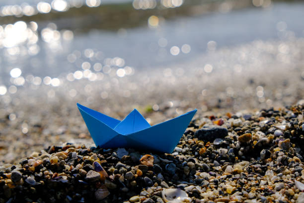 istock Blue paper boat on a beach 1138003654