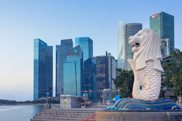 Downtown Singapore View of the merlion statue of Merlion Park, and the financial district in downtown Singapore. The merlion is a symbol and mascot of Singapore. singapore stock pictures, royalty-free photos & images