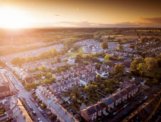 istock Sun setting with atmospheric effect over traditional British houses and tree lined streets. 1138004579