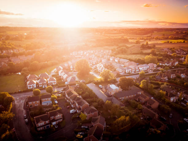 istock Sun setting with atmospheric effect over traditional British houses and tree lined streets. 1138004612