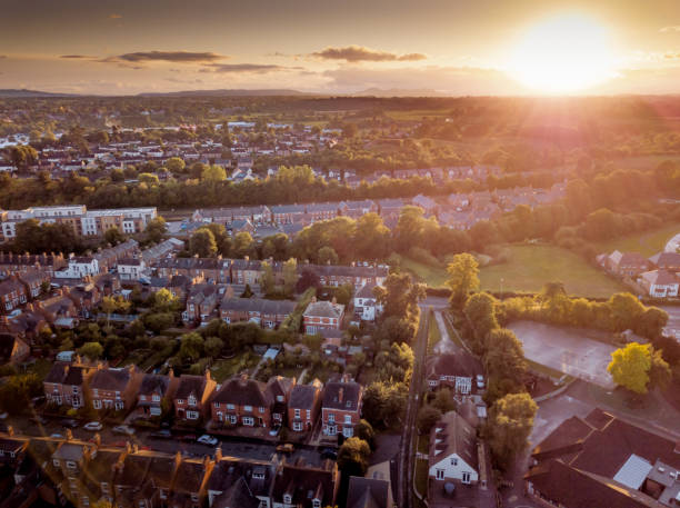 istock Sun setting with atmospheric effect over traditional British houses and tree lined streets. 1138004695