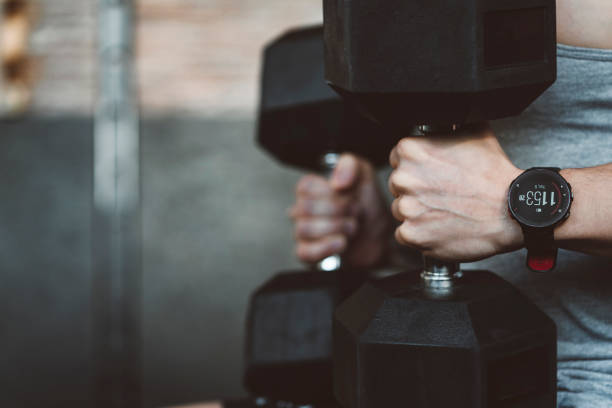 istock A close up of a man holding two heavy weights 1138004709