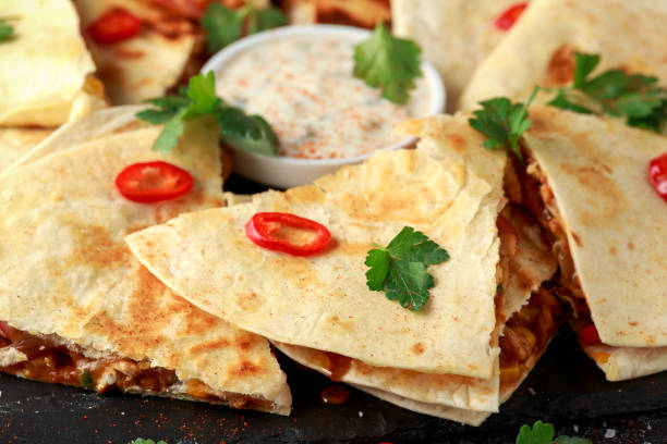 istock Mexican quesadilla with chicken, cheese and peppers, yogurt dip and chilli. 1138004996
