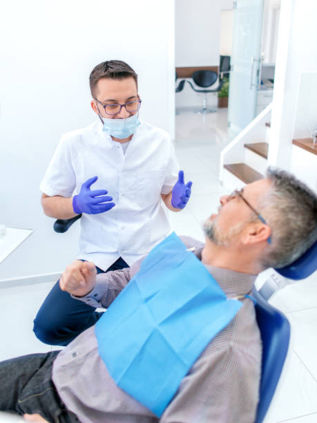 istock Mature man at the dentist 1138006143