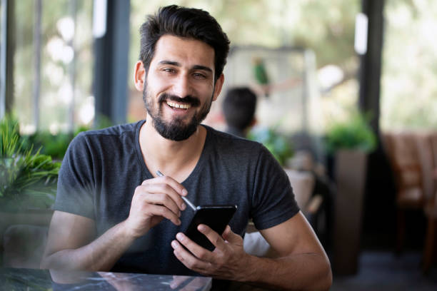 indian man at cafe - espresso men coffee shop drinking stock-fotos und bilder