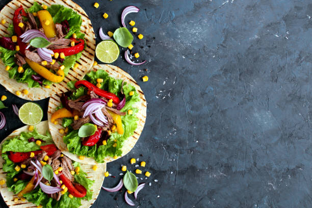 Tortillas flat various vegetables and beef for tacos or burrito on stone background.