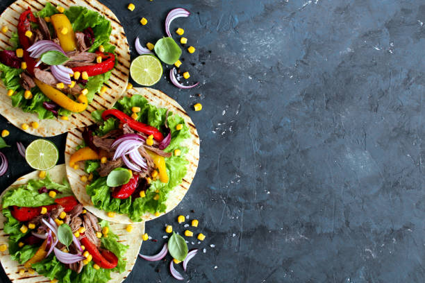 Tortillas flat various vegetables and beef for tacos or burrito on stone background. stock photo