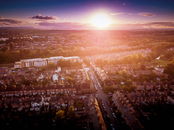 istock Sun setting with atmospheric effect over traditional British houses and tree lined streets. 1138011093