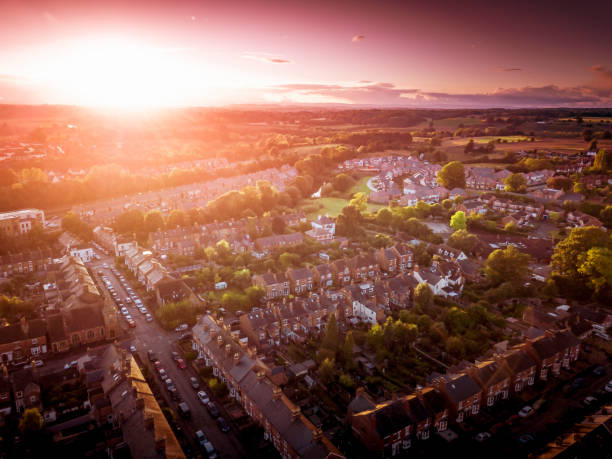 istock Sun setting with atmospheric effect over traditional British houses and tree lined streets. 1138011114