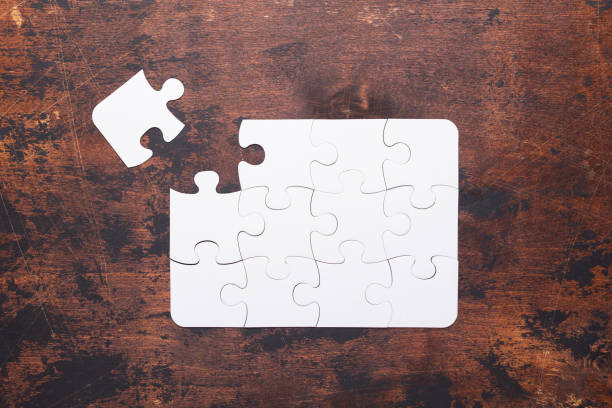 istock Jigsaw Puzzle with missing piece on old wooden background Top view 1138011174