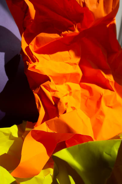 istock Wrinkled Orange and yellow papers on gray background 1138013950