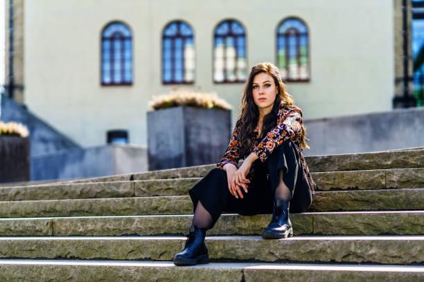 istock Stylish woman sitting on steps 1138013963