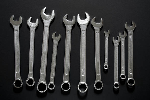 istock Spanner Set. Silver coloured spanners lying side by side in black background. 1138015142