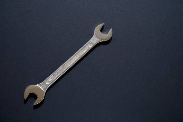 istock Spanner wrench on black background, Open box wrench chrome engineering instrument 1138015861