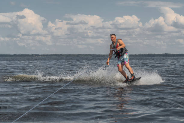 istock Tense man wakeboarding in a lake and pulled by a boat 1138016531