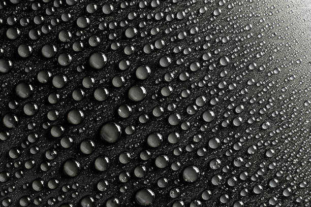 istock Droplets of water on a black, matte background illuminated with a delicate light. 1138017144