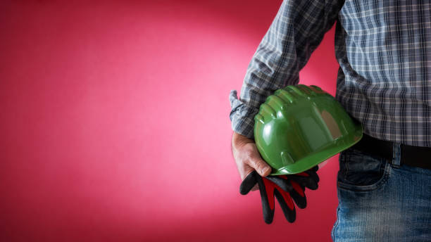 istock House painter worker with helmet and gloves in hand. Building. 1138018096