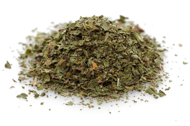 Heap of dried mint leaves isolated on white