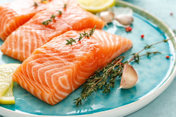 istock Seafood. Fresh raw salmon or trout fillets with ingredients 1138018341