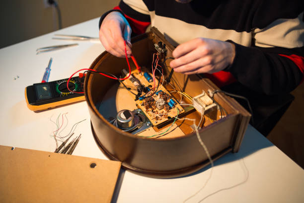 istock Man is repairing an old radio 1138019575