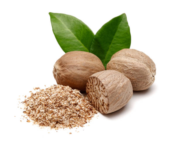 Whole and grated nutmeg with leaves isolated