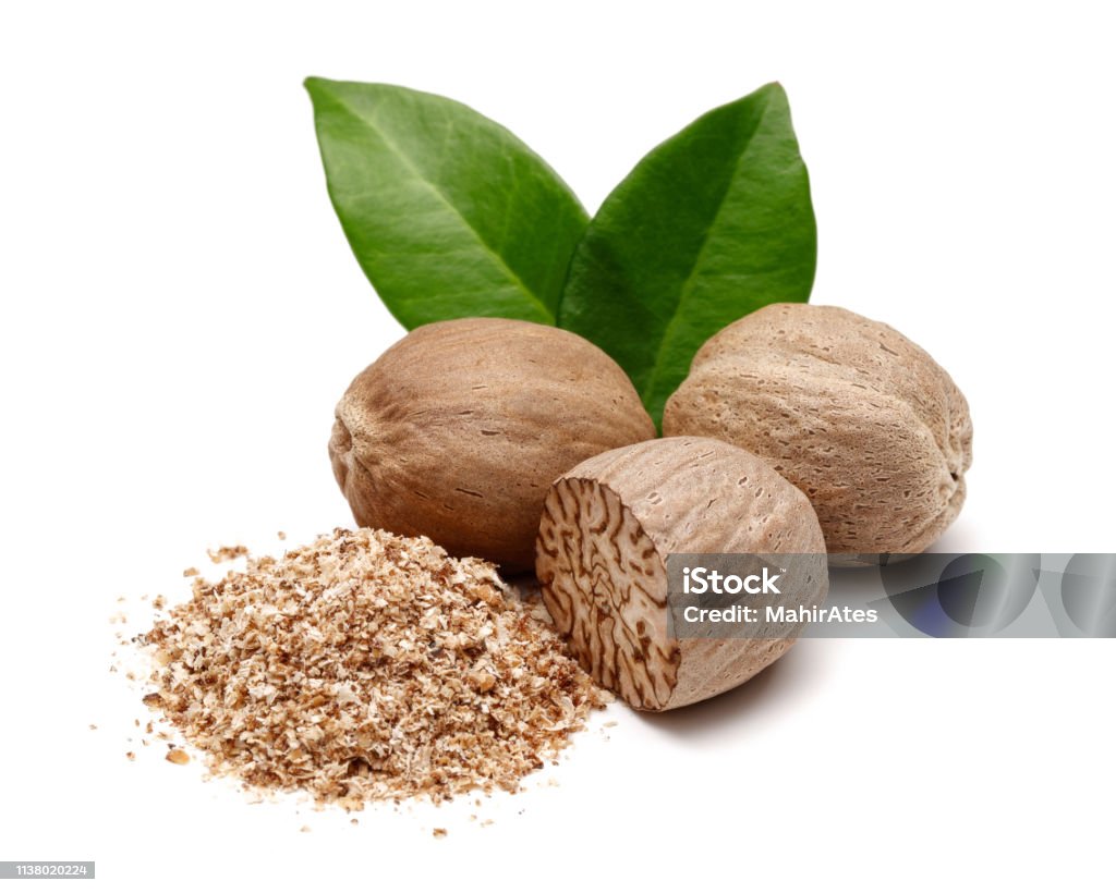 Whole and grated nutmeg with leaves isolated Whole and grated nutmeg with leaves isolated on white background Nutmeg Stock Photo