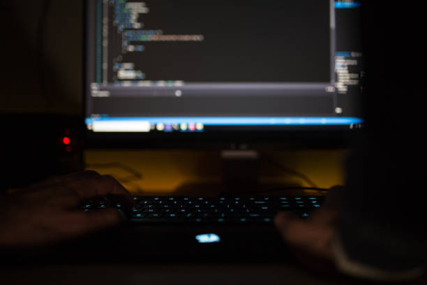 istock Cyber hacking in a dark room by mysterious man 1138020293