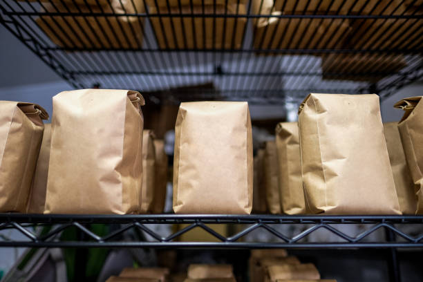 Bags of Coffee for Sale Stacked on Coffee Shop Shelf stock photo