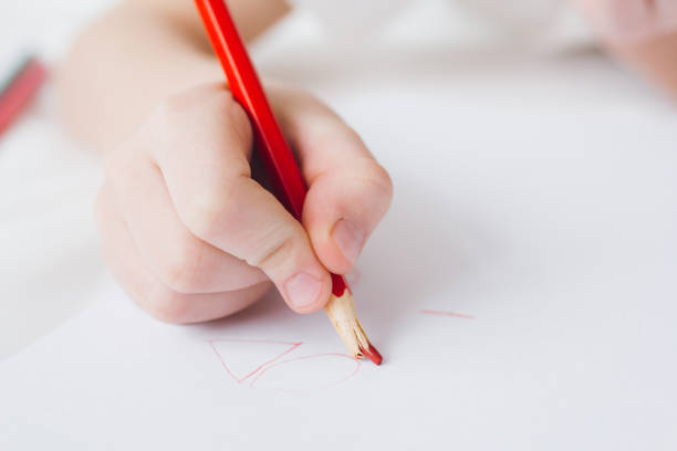 istock Boy draws with colorful pencils sitting on the bed 1138022530