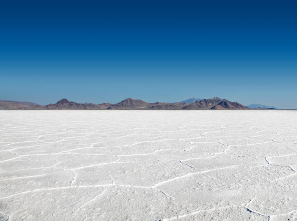 Stark Beauty of the Bonneville Salt Flats Panoramic view of the stark white Bonneville Salt Flats with mountains in the distance bonneville salt flats stock pictures, royalty-free photos & images