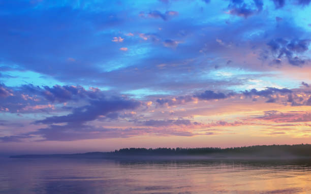 istock Amazing Sunset Over The Forested Shore Of The Lake 1138024074